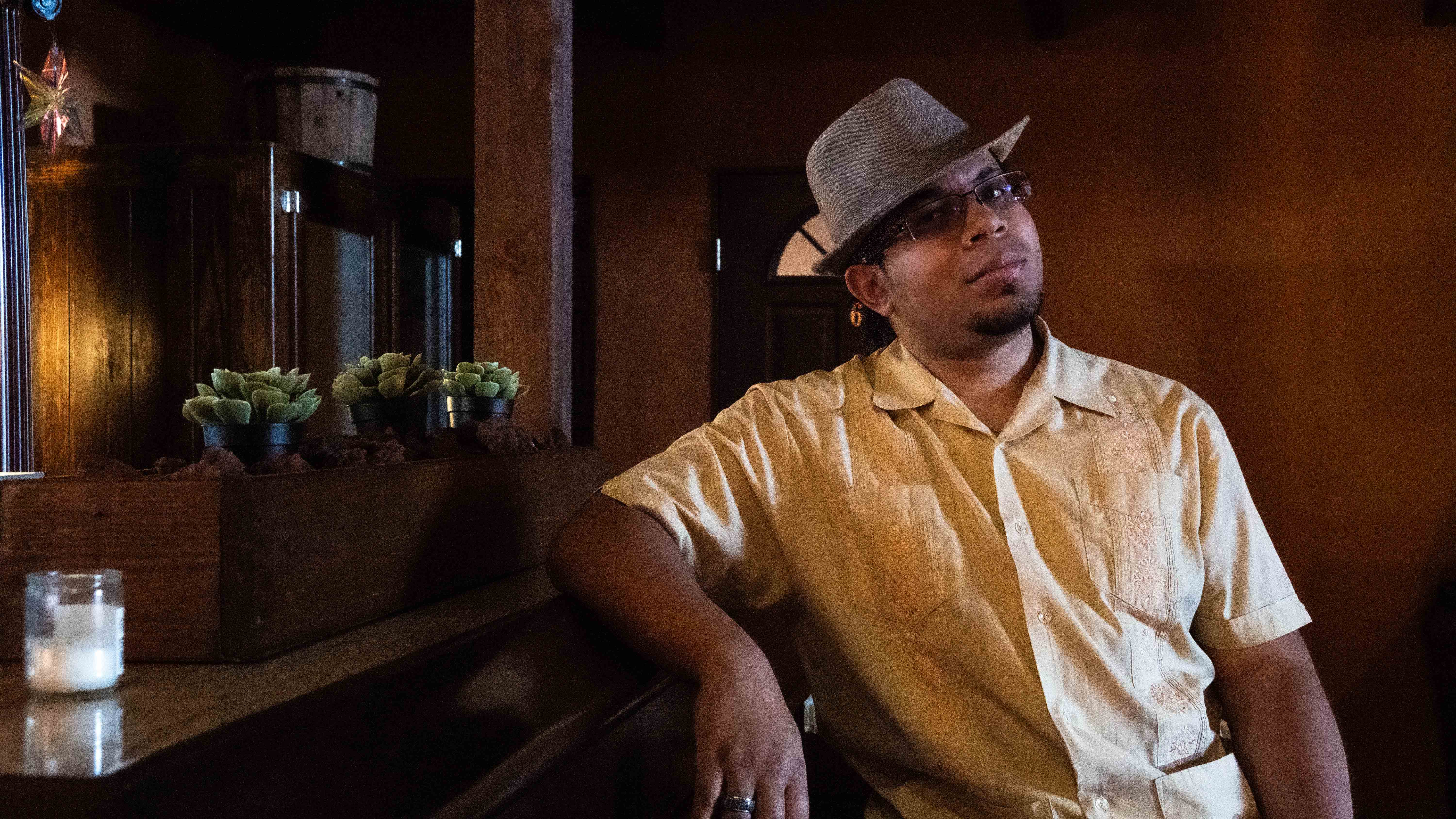 Angel leaning casually against an old saloon bar, looking sideways at the camera